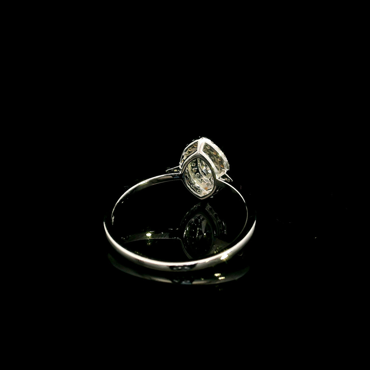 Marquise diamond halo engagement ring in 18K white gold with a marquise centre diamond surrounded by a sparkling diamond halo.