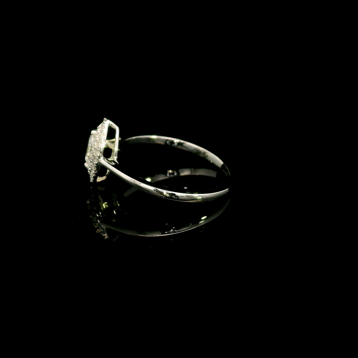 Marquise diamond halo engagement ring in 18K white gold with a marquise centre diamond surrounded by a sparkling diamond halo.