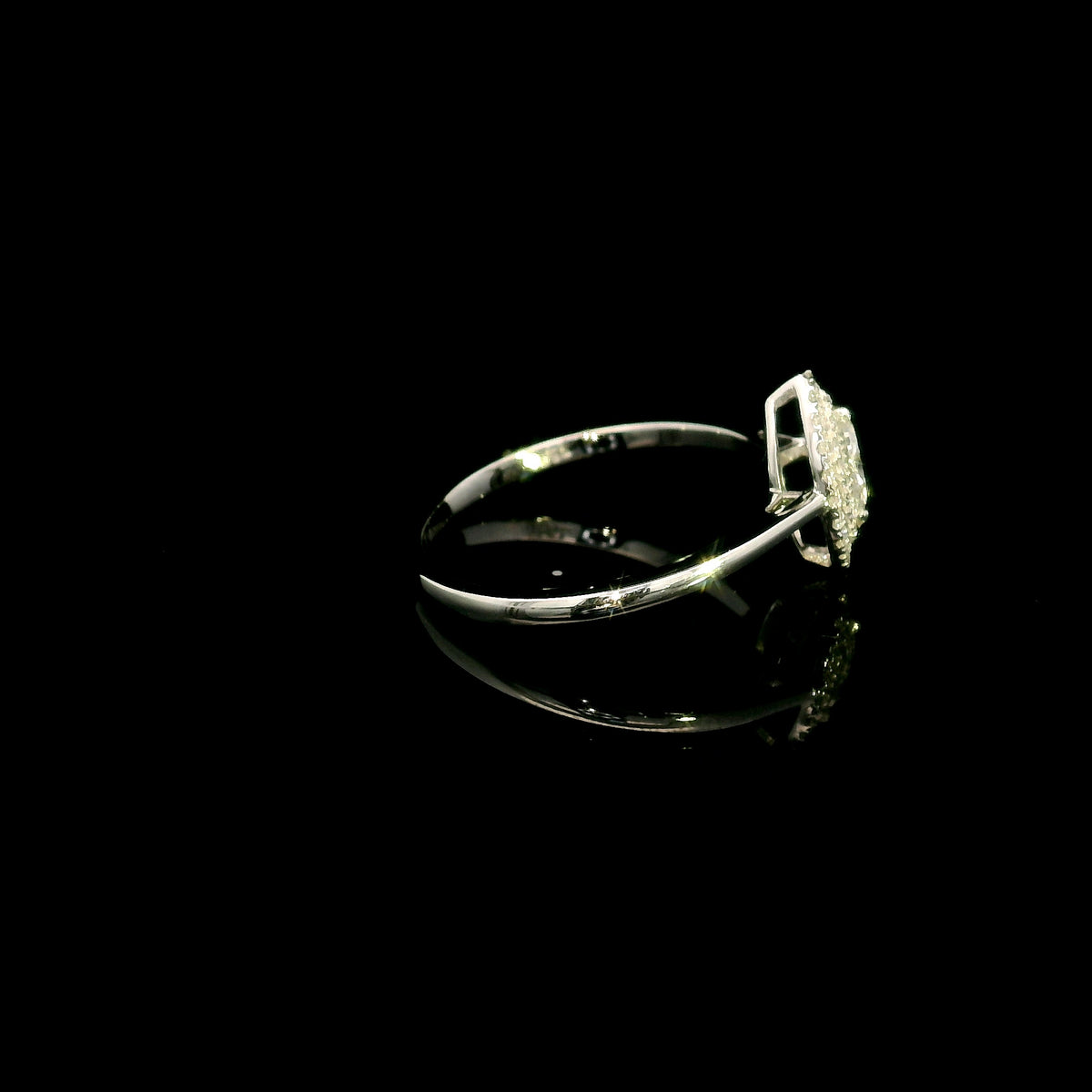 Marquise diamond halo engagement ring in 18K white gold with a marquise centre diamond surrounded by a sparkling diamond halo.