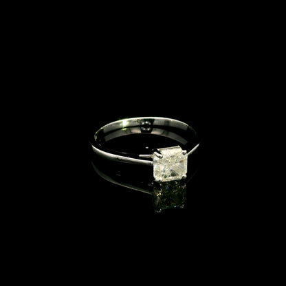 Radiant cut diamond solitaire engagement ring in 18K white gold with a four-prong setting and polished band.