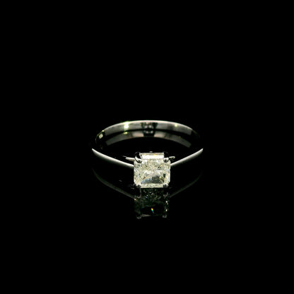 Radiant cut diamond solitaire engagement ring in 18K white gold with a four-prong setting and polished band.