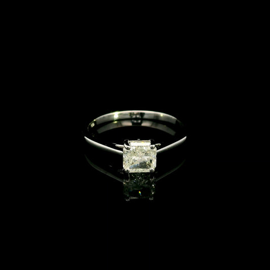 Radiant cut diamond solitaire engagement ring in 18K white gold with a four-prong setting and polished band.