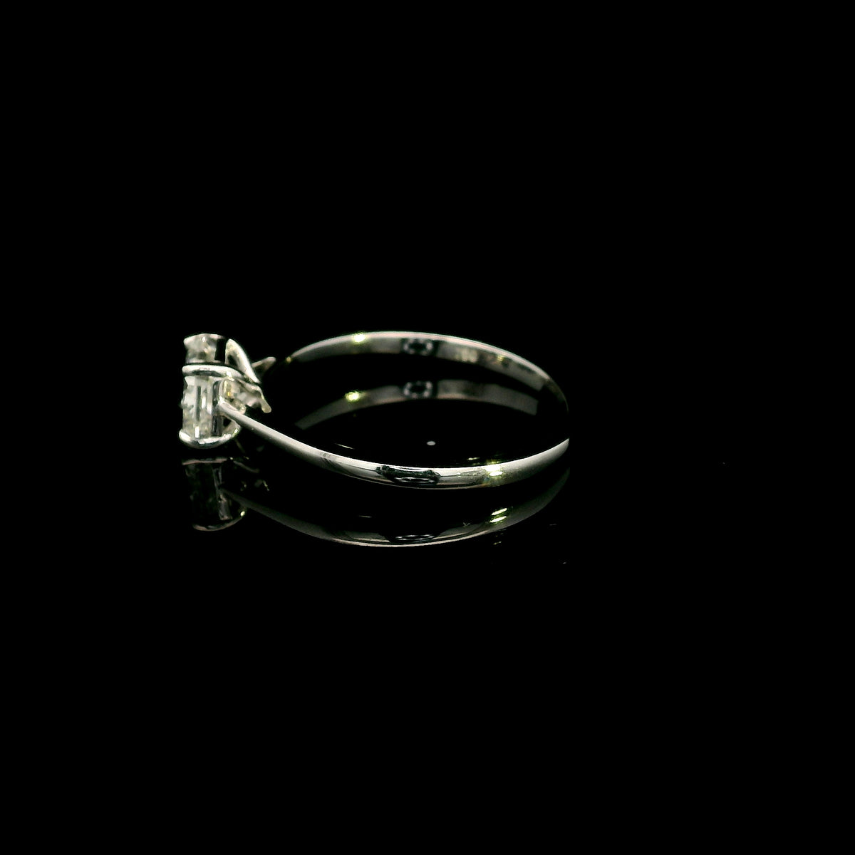 Radiant cut diamond solitaire engagement ring in 18K white gold with a four-prong setting and polished band.