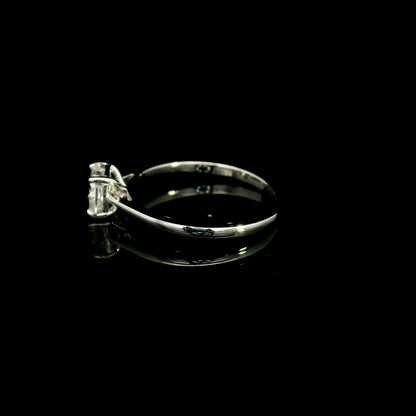 Radiant cut diamond solitaire engagement ring in 18K white gold with a four-prong setting and polished band.