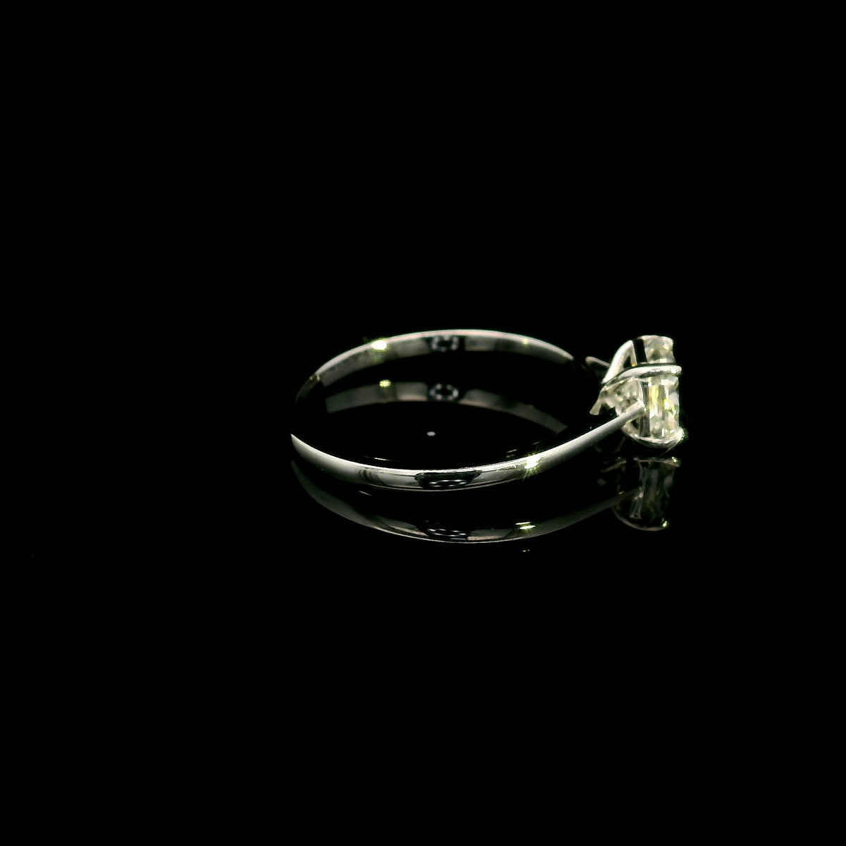 Radiant cut diamond solitaire engagement ring in 18K white gold with a four-prong setting and polished band.
