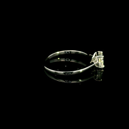 Radiant cut diamond solitaire engagement ring in 18K white gold with a four-prong setting and polished band.