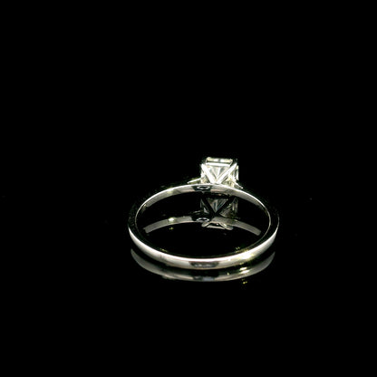 Radiant cut diamond solitaire engagement ring in 18K white gold with a four-prong setting and polished band.