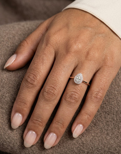 Pear shaped diamond halo ring in 18K white gold with round diamond halo