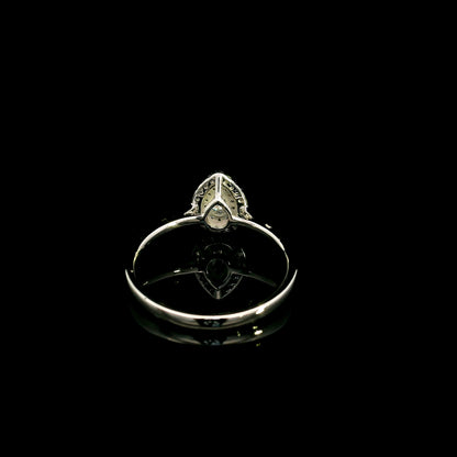 Pear shaped diamond halo ring in 18K white gold with round diamond halo