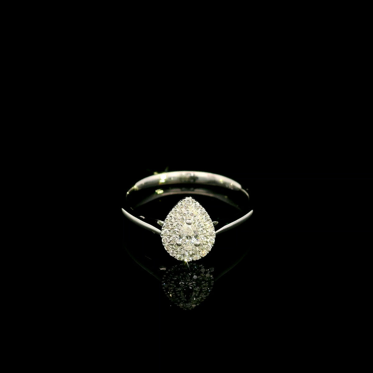 Pear shaped diamond halo ring in 18K white gold with round diamond halo