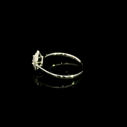 Pear shaped diamond halo ring in 18K white gold with round diamond halo