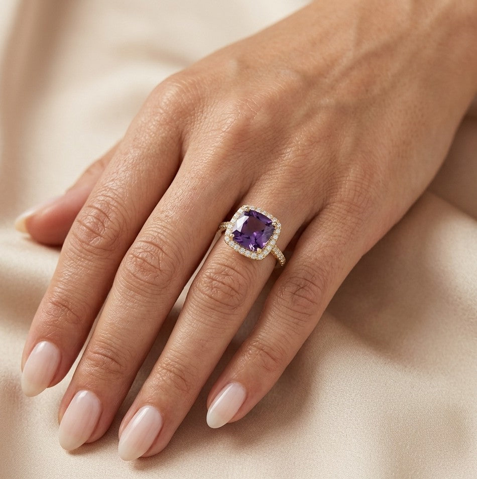 18K yellow gold cushion amethyst and diamond halo ring with purple amethyst, round diamond surround and diamond-set band