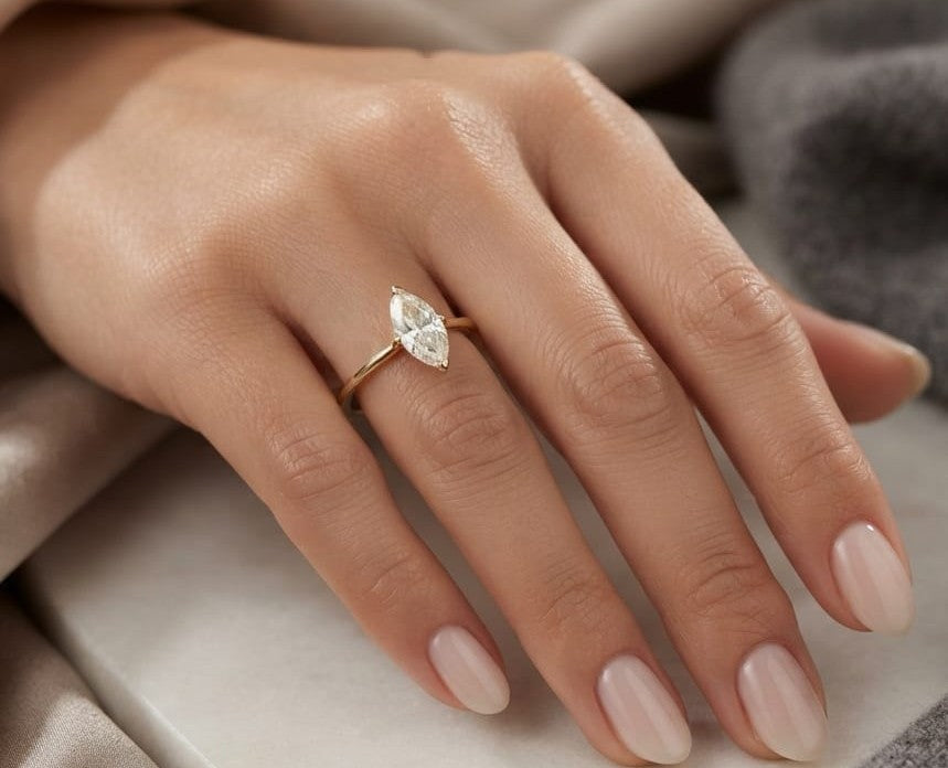 Marquise diamond solitaire engagement ring in 18K yellow gold with an IGI certified natural diamond.
