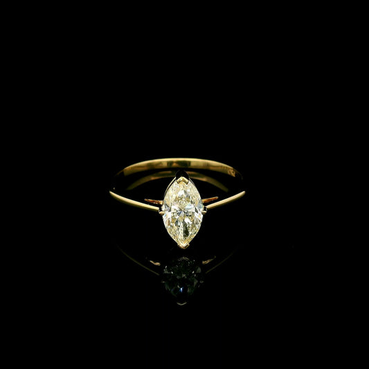 Marquise diamond solitaire engagement ring in 18K yellow gold with an IGI certified natural diamond.