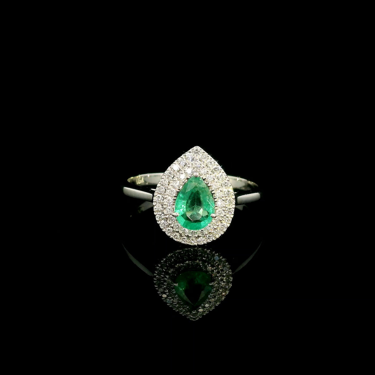 18K white gold pear shaped emerald and diamond halo ring with green emerald surrounded by round diamonds