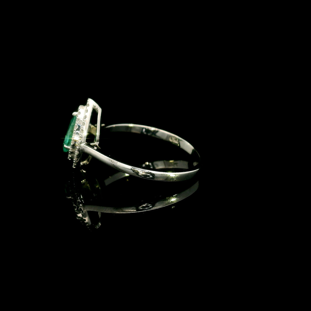 18K white gold pear shaped emerald and diamond halo ring with green emerald surrounded by round diamonds
