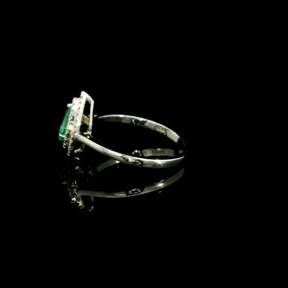 18K white gold pear shaped emerald and diamond halo ring with green emerald surrounded by round diamonds