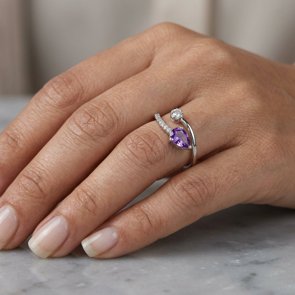 Amethyst and diamond ring in 18K white gold with pear shaped amethyst, diamond cluster and open band
