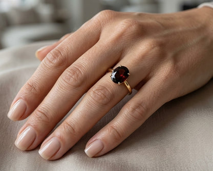 Oval garnet solitaire ring in 18K yellow gold