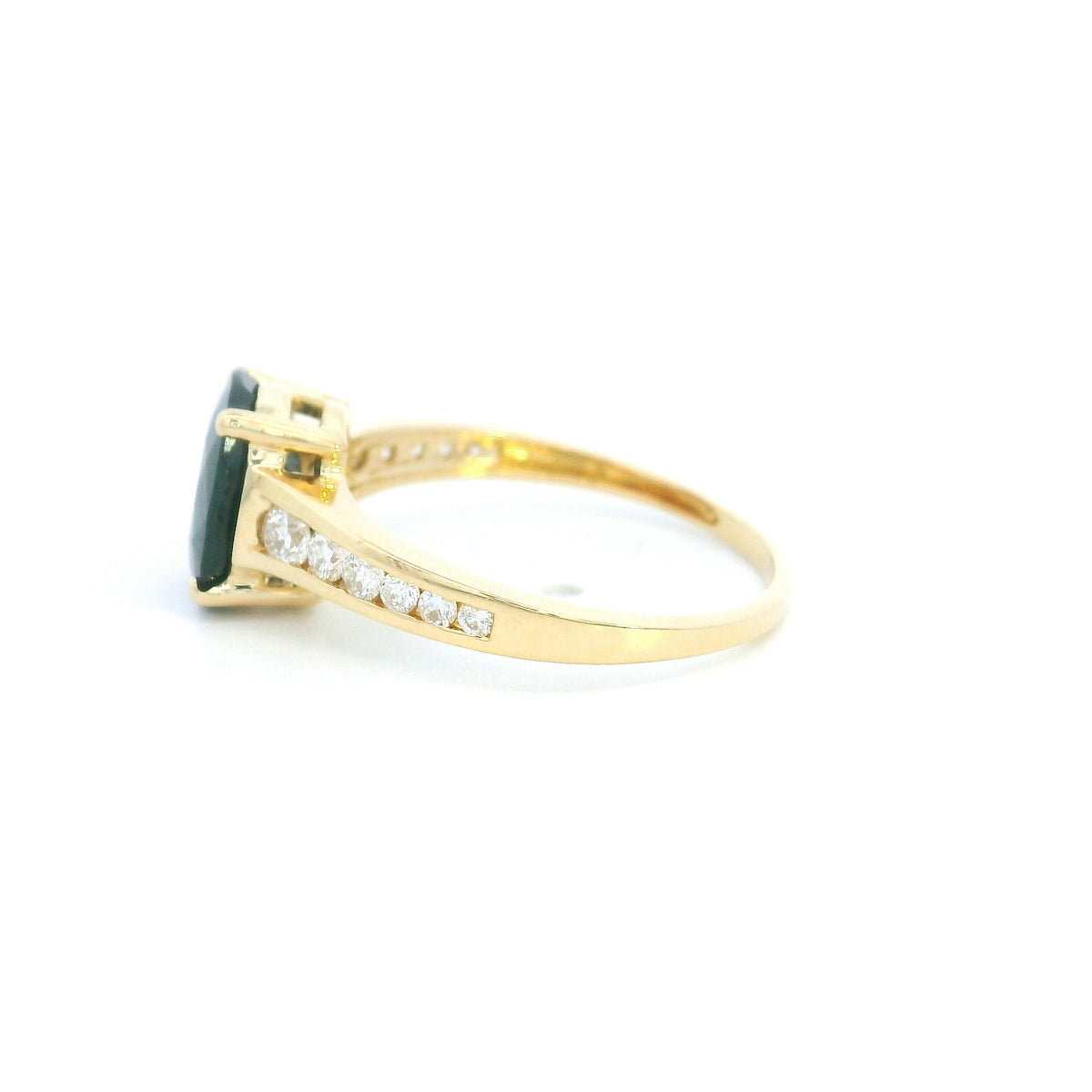 Blue sapphire and diamond ring in 18K yellow gold featuring an oval blue sapphire with round brilliant diamond-set shoulders.