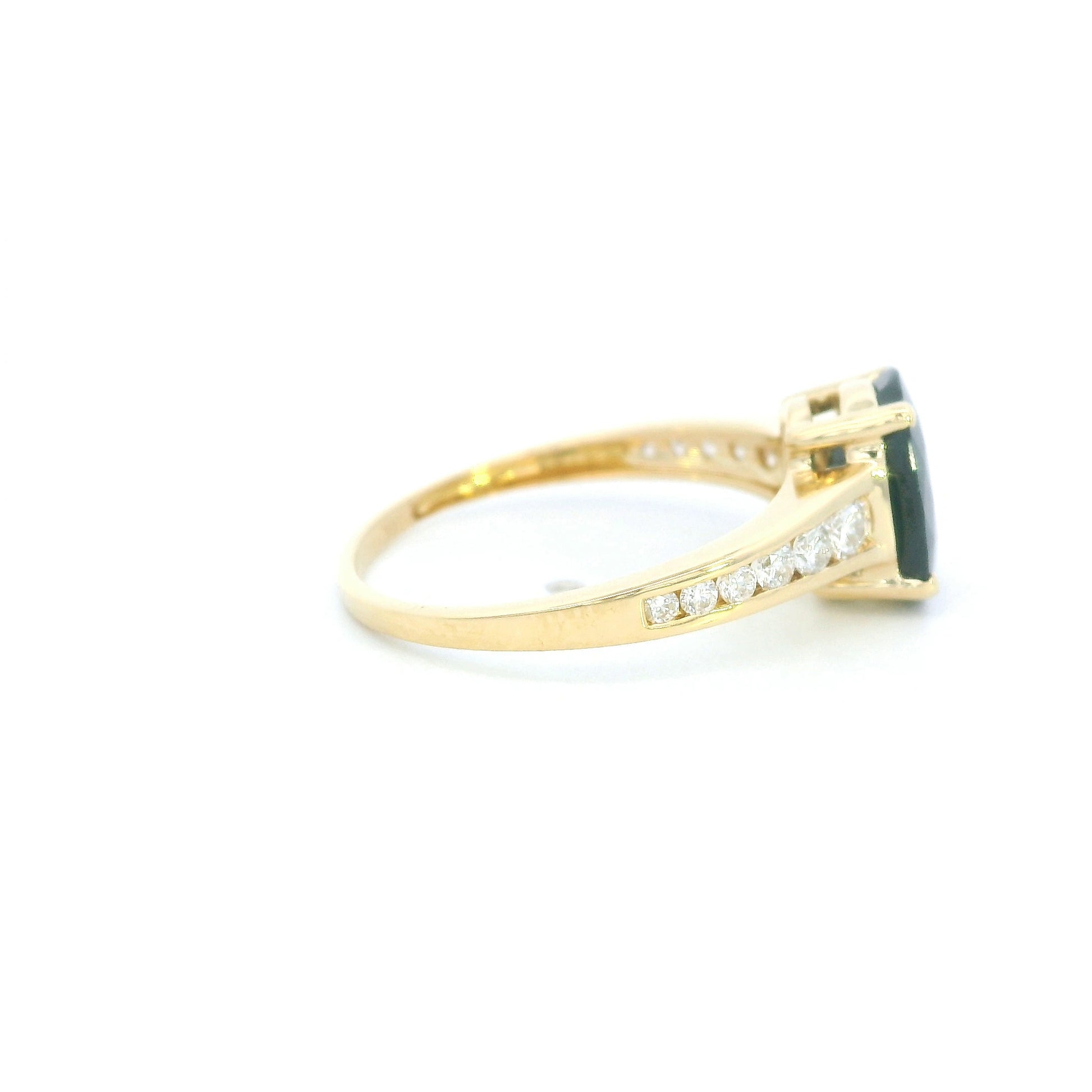 Blue sapphire and diamond ring in 18K yellow gold featuring an oval blue sapphire with round brilliant diamond-set shoulders.