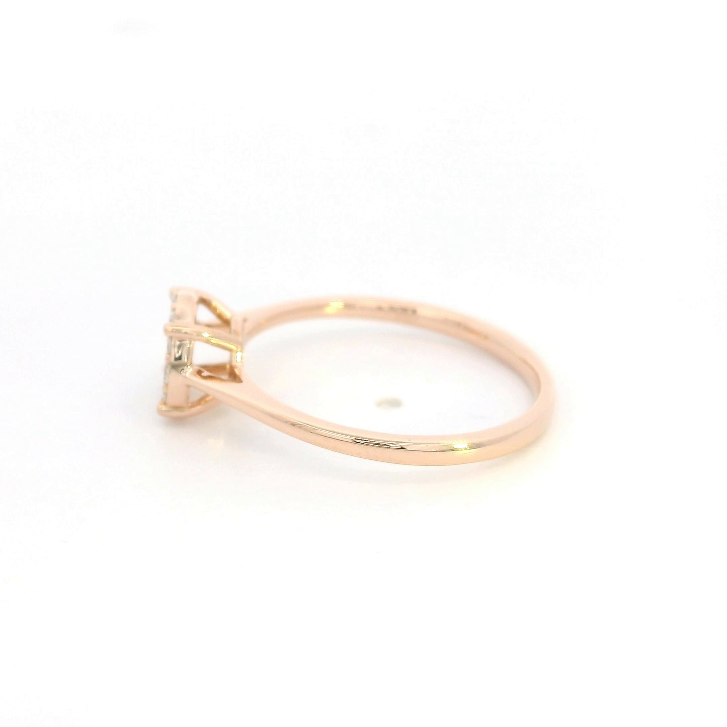 Diamond cluster ring in 18K rose gold featuring round brilliant diamonds arranged across a delicate polished band.