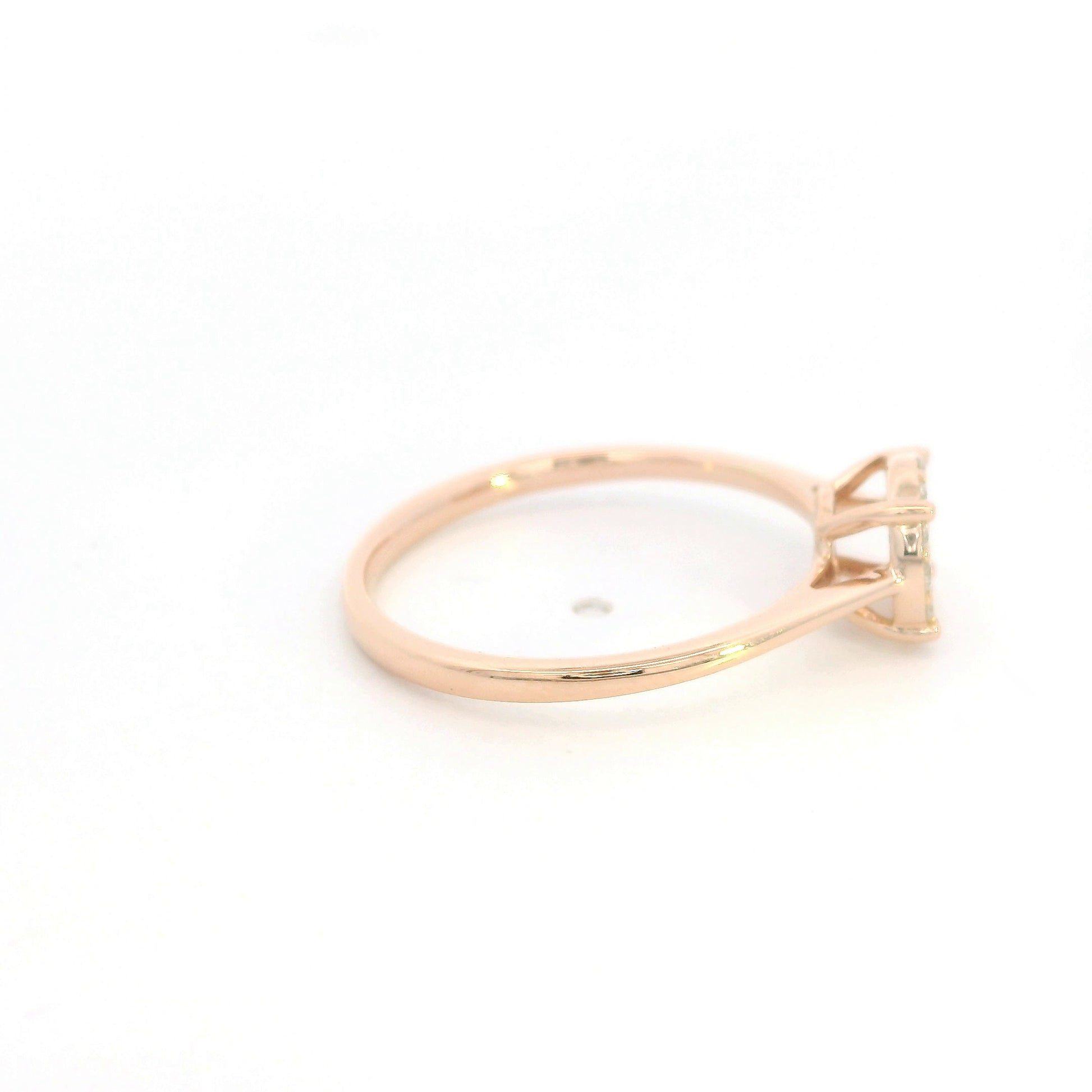 Diamond cluster ring in 18K rose gold featuring round brilliant diamonds arranged across a delicate polished band.