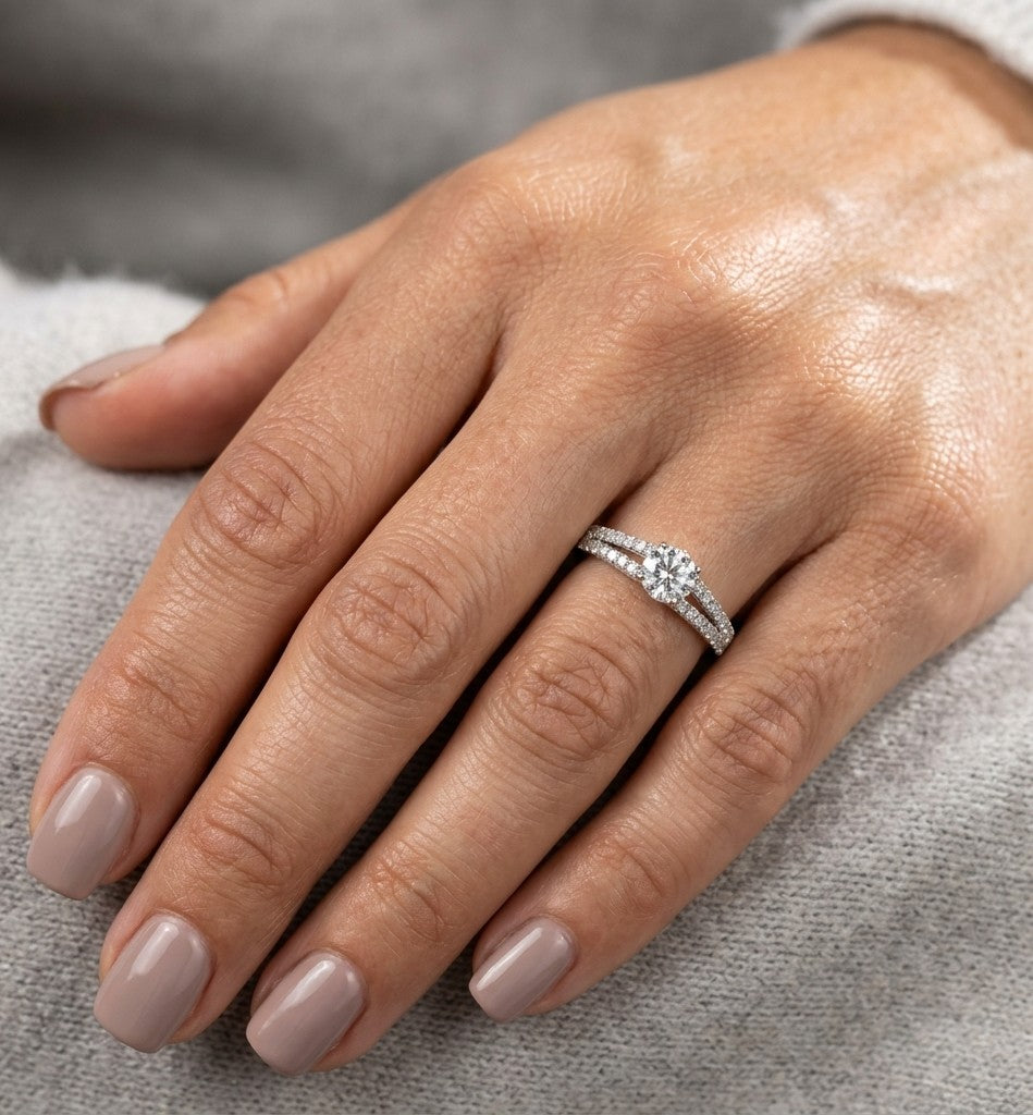 Round diamond split shank engagement ring in 18K white gold with diamond-set band