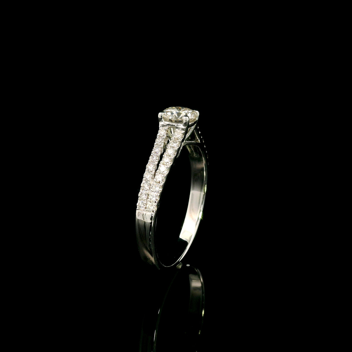 Round diamond split shank engagement ring in 18K white gold with diamond-set band