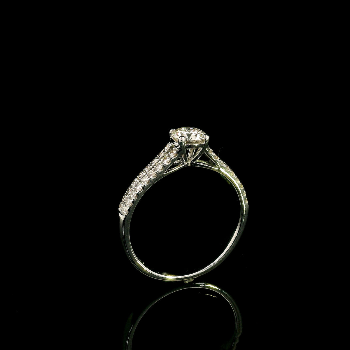 Round diamond split shank engagement ring in 18K white gold with diamond-set band