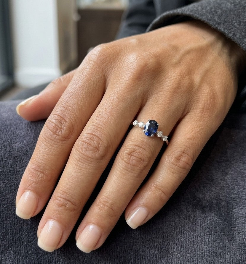 Oval blue sapphire diamond ring in 18K white gold with round diamond side stones