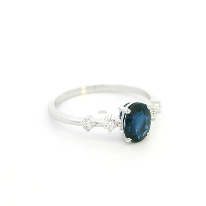 Oval blue sapphire diamond ring in 18K white gold with round diamond side stones