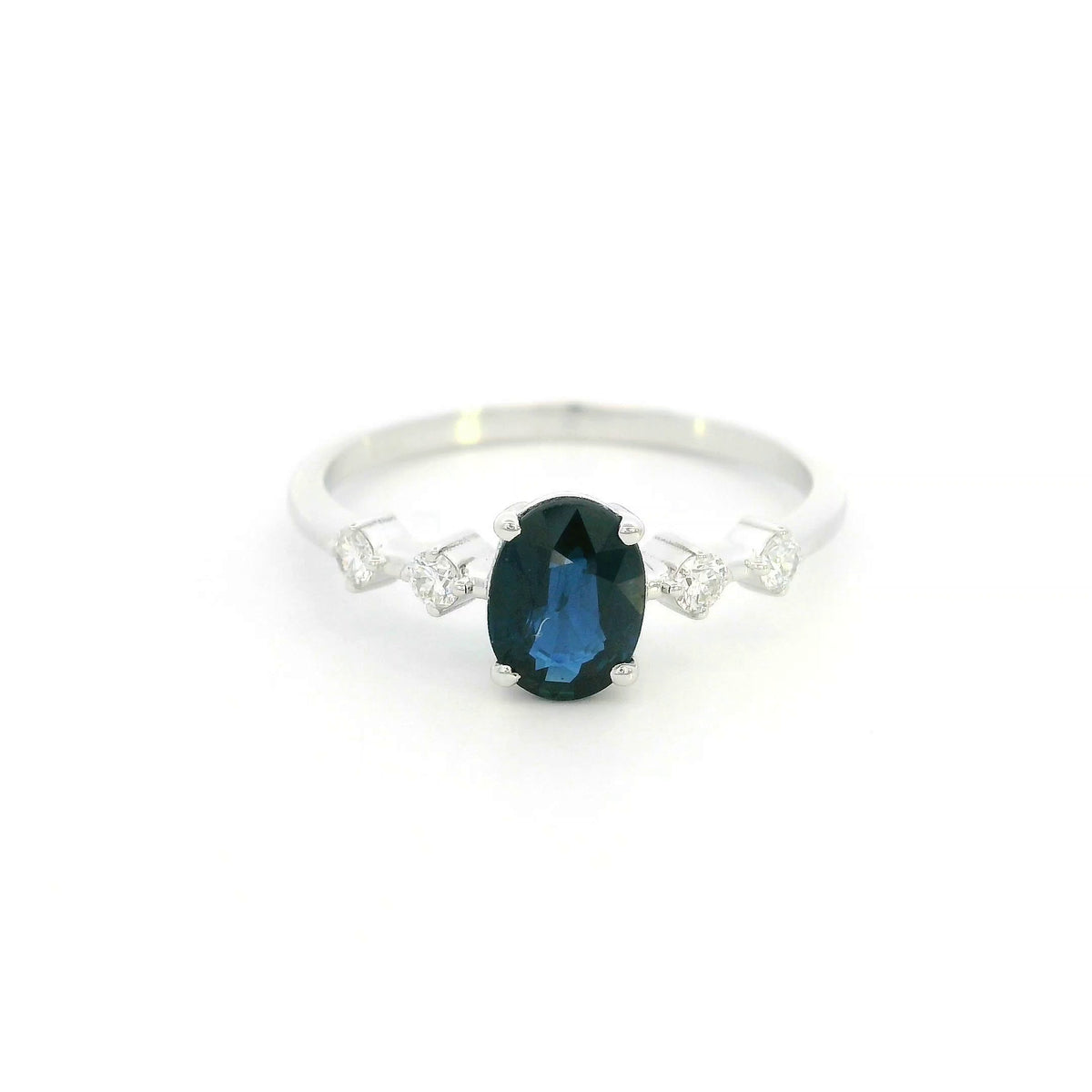 Oval blue sapphire diamond ring in 18K white gold with round diamond side stones