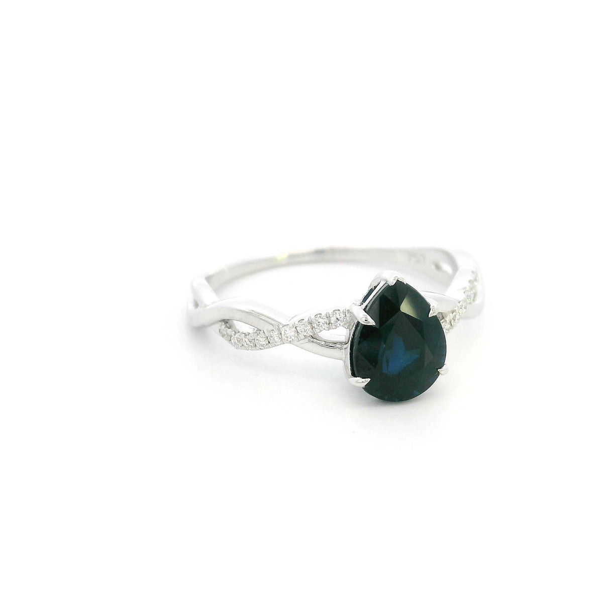 Pear shaped blue sapphire and diamond twist ring in 18K white gold
