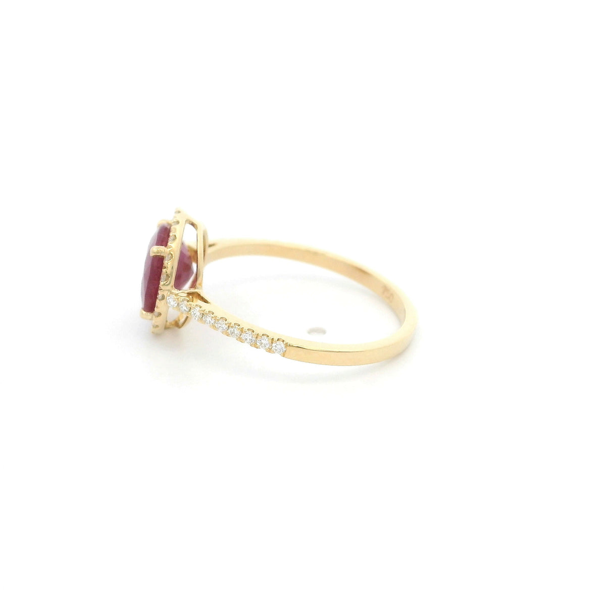 Ruby and diamond halo ring in 18K yellow gold featuring a round red ruby surrounded by diamonds with diamond-set shoulders.