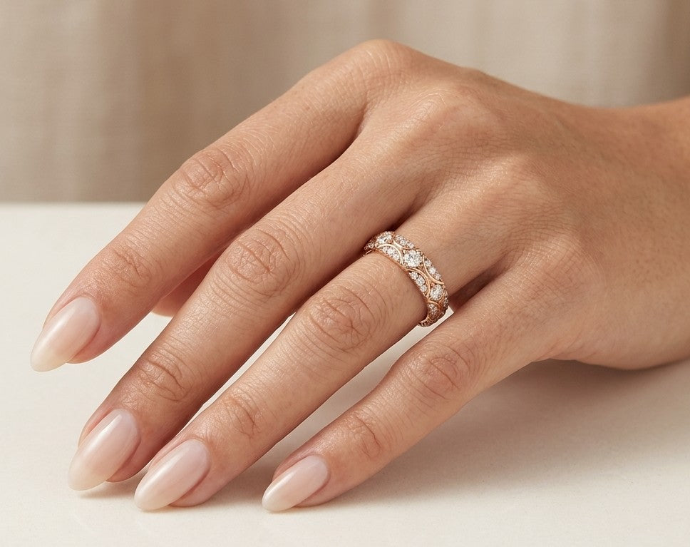 Vintage-style diamond eternity band in 18K rose gold with round diamonds and intricate curved detailing