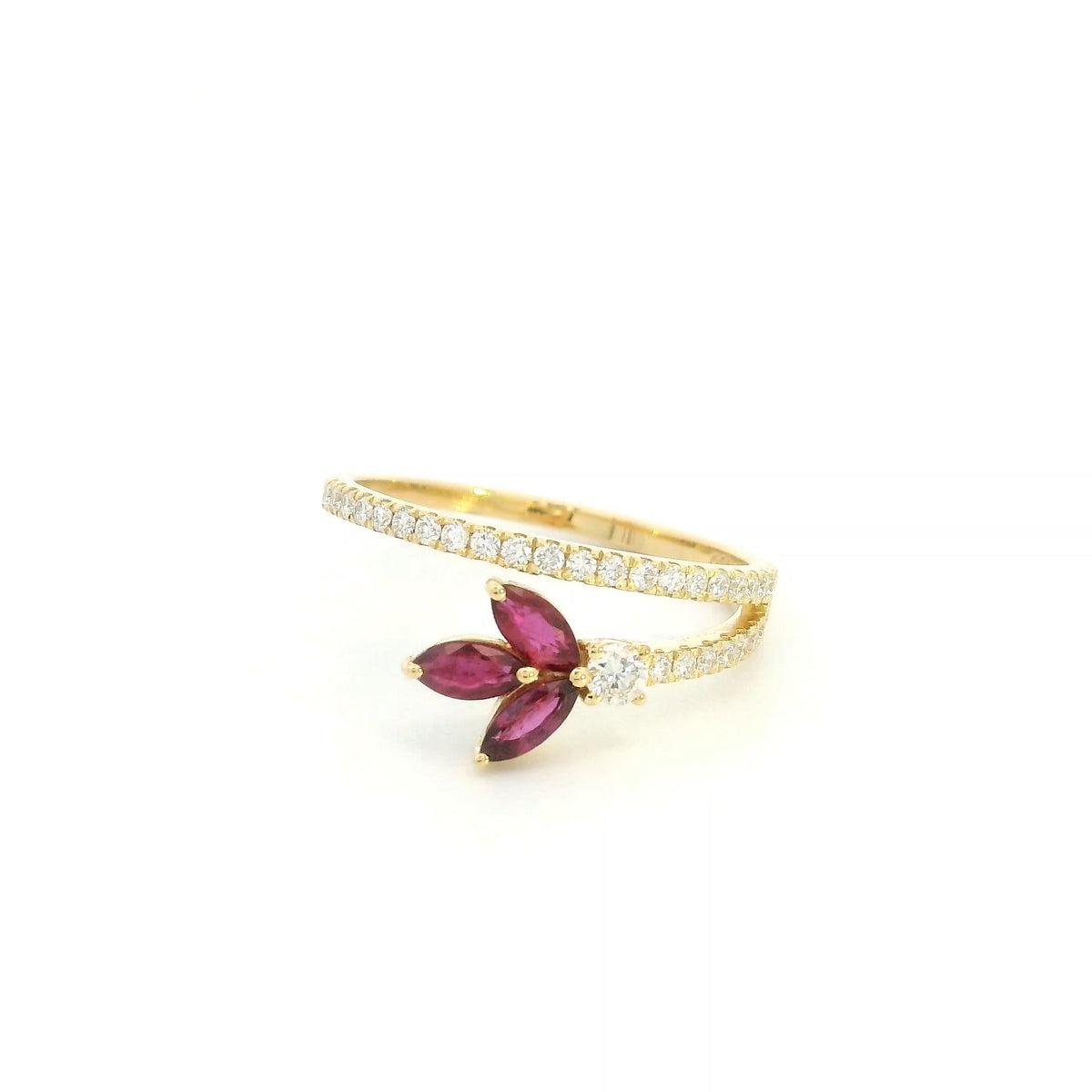 Ruby and diamond floral ring in 18K yellow gold with three marquise shaped rubies and sweeping diamond-set bands.