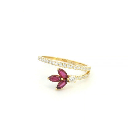 Ruby and diamond floral ring in 18K yellow gold with three marquise shaped rubies and sweeping diamond-set bands.