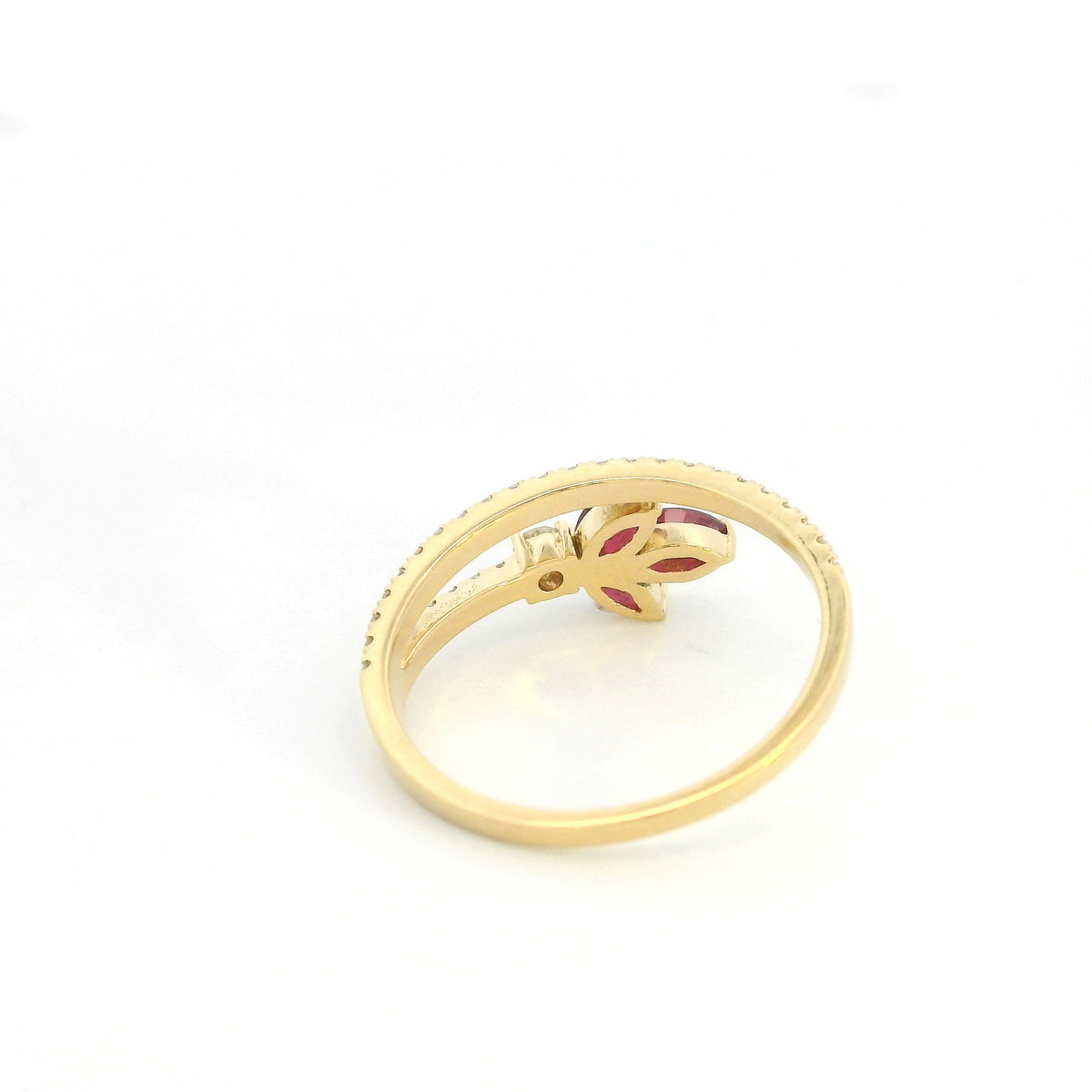 Ruby and diamond floral ring in 18K yellow gold with three marquise shaped rubies and sweeping diamond-set bands.