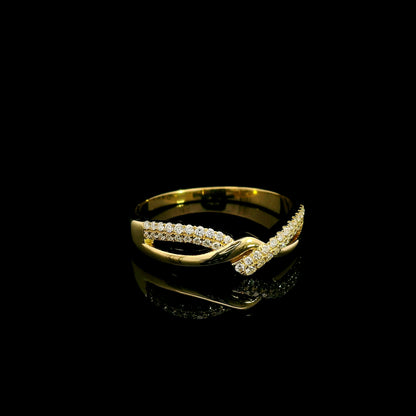 Diamond crossover ring in 18K yellow gold with polished and pavé diamond twist design