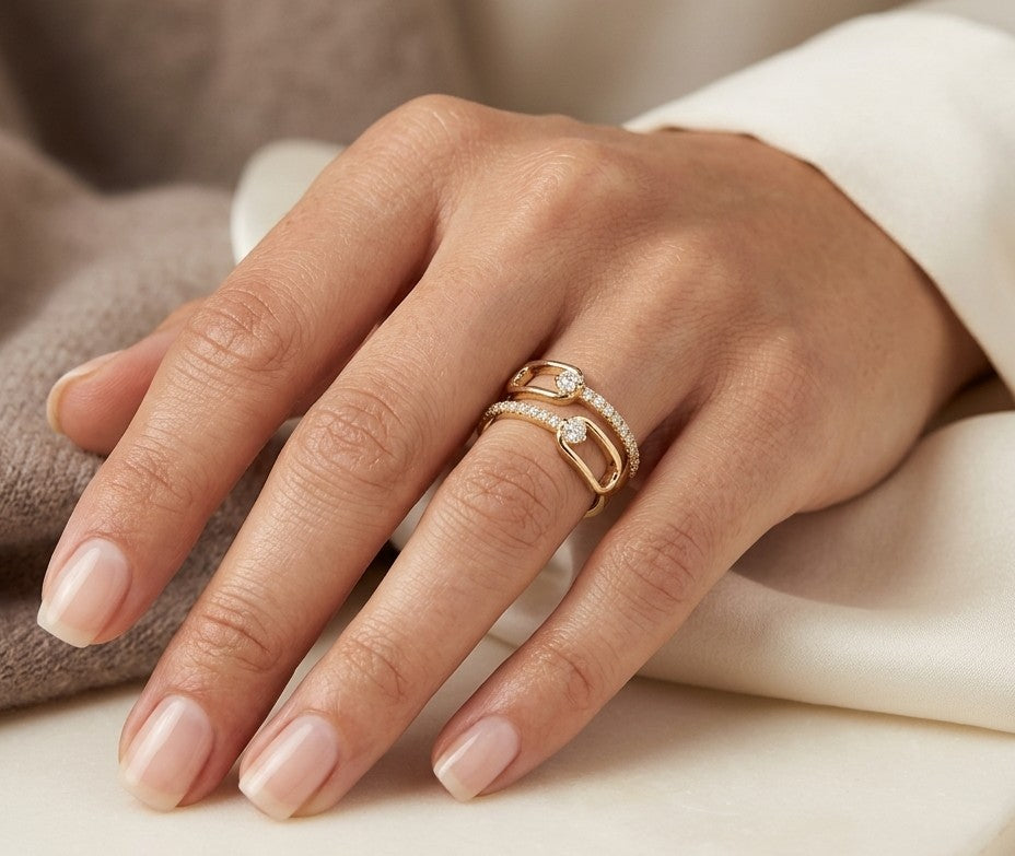 Diamond open bypass ring in 18K yellow gold with round diamonds, sweeping diamond-set curves and polished gold loops.