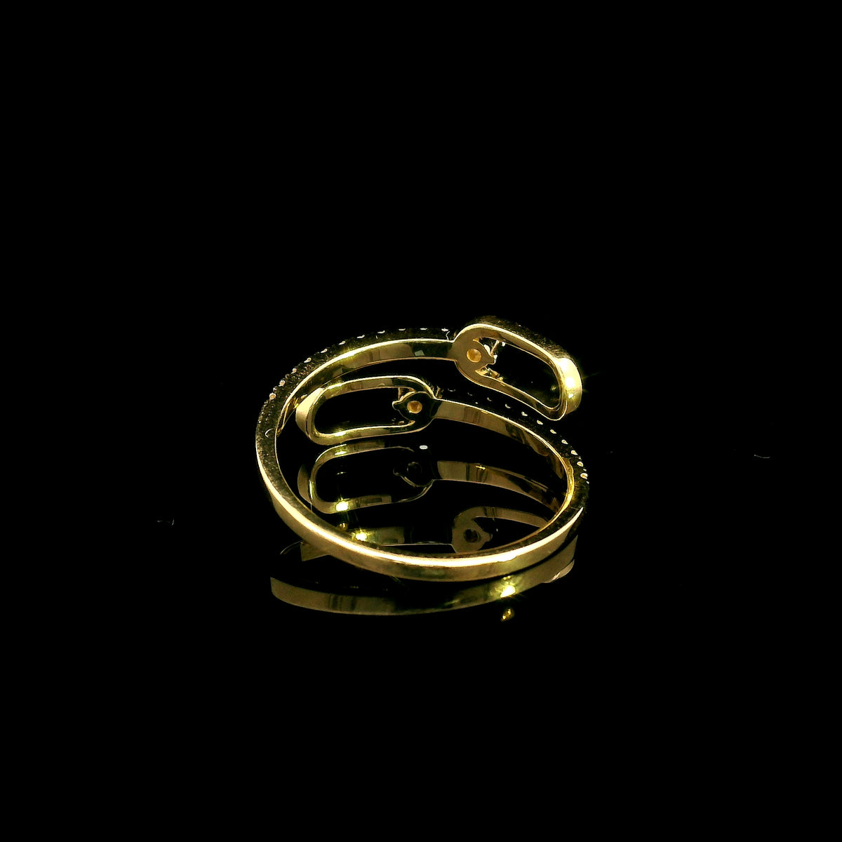 Diamond open bypass ring in 18K yellow gold with round diamonds, sweeping diamond-set curves and polished gold loops.