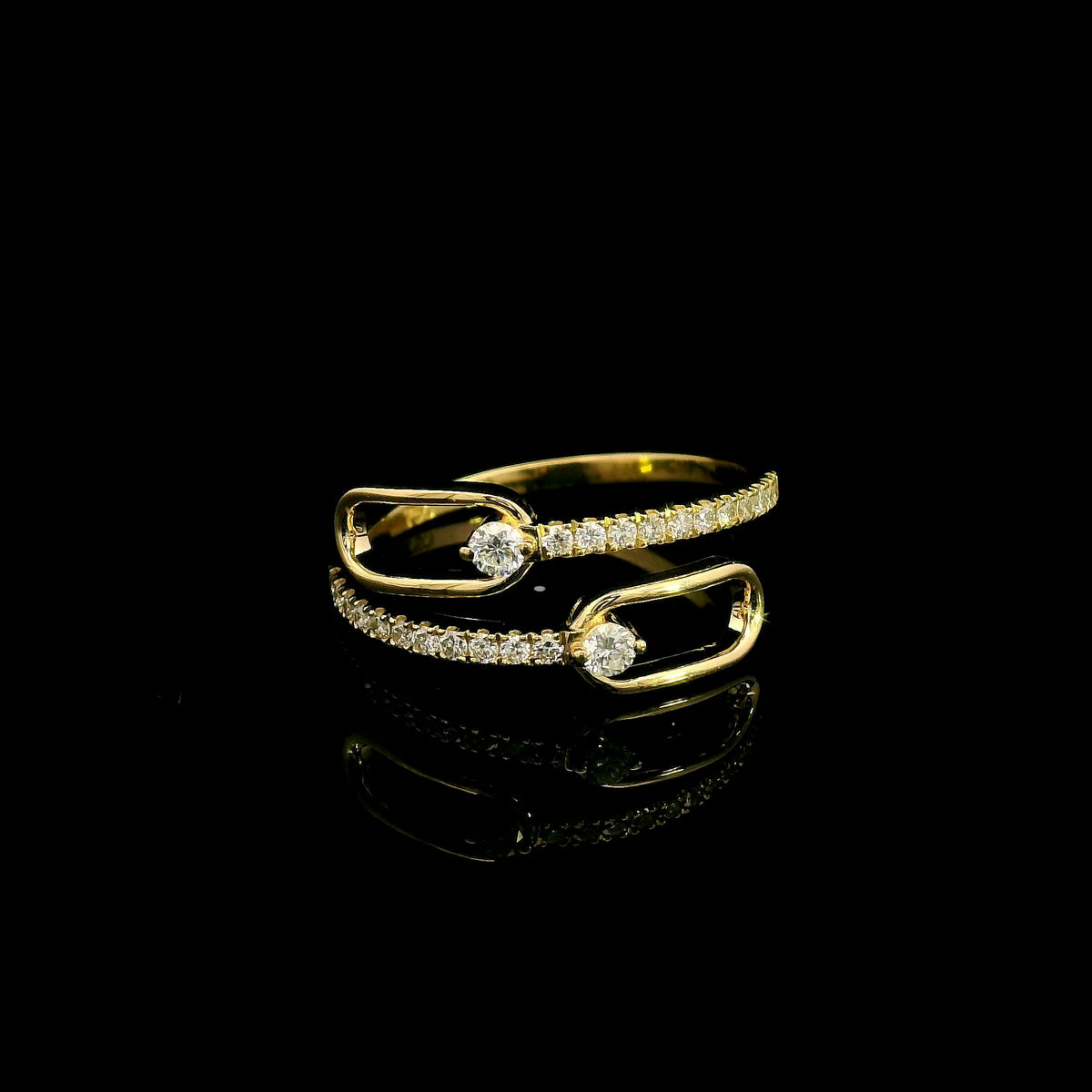 Diamond open bypass ring in 18K yellow gold with round diamonds, sweeping diamond-set curves and polished gold loops.