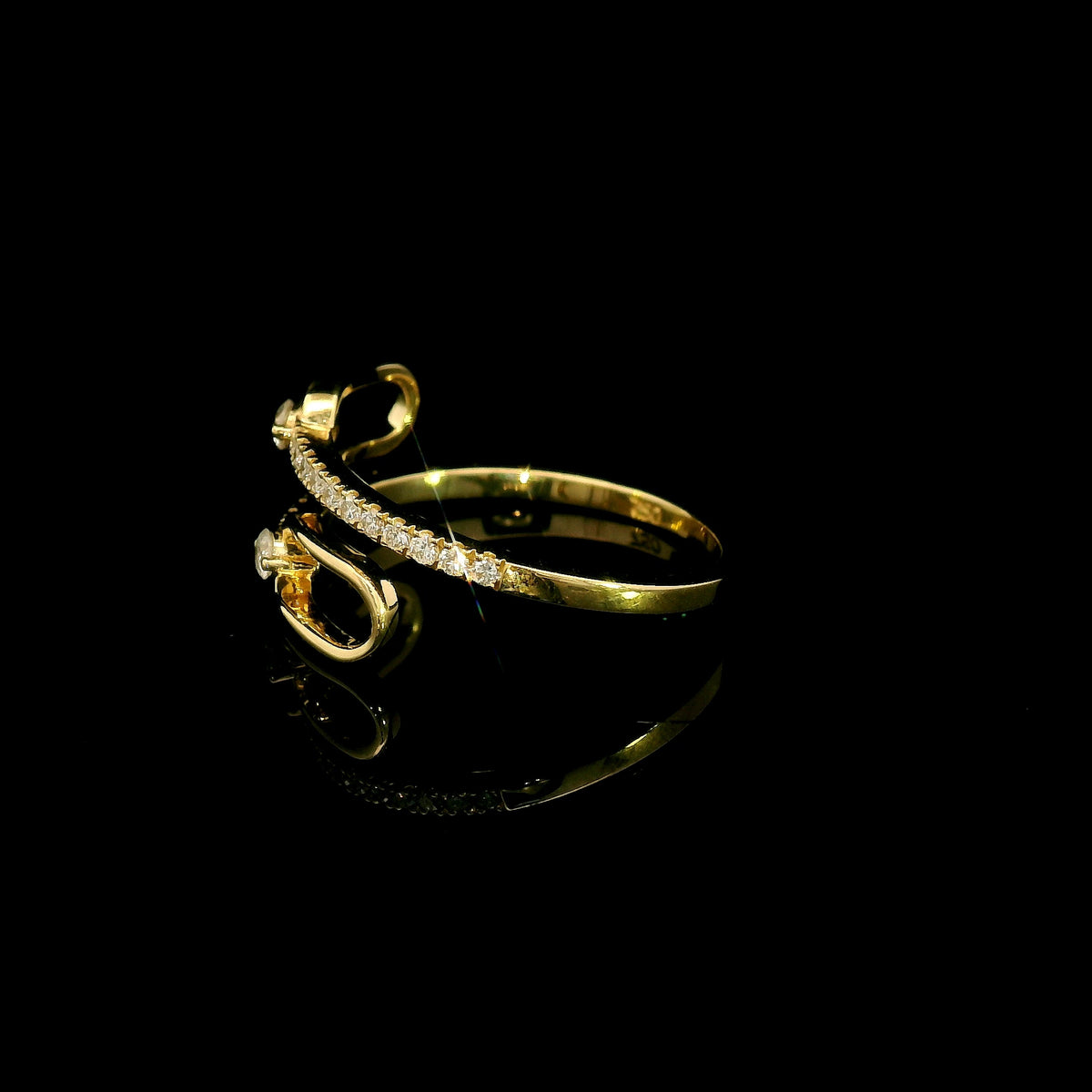 Diamond open bypass ring in 18K yellow gold with round diamonds, sweeping diamond-set curves and polished gold loops.