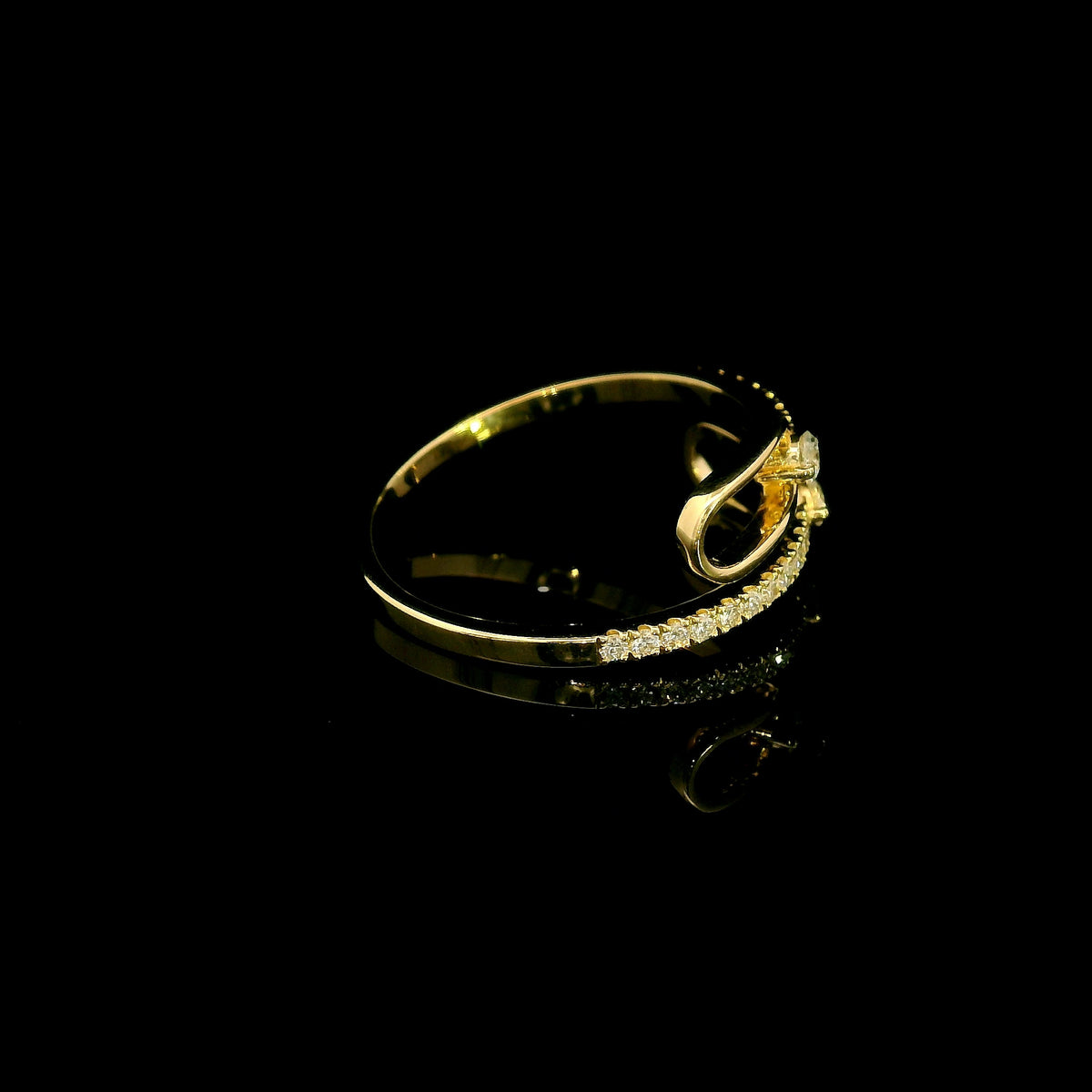 Diamond open bypass ring in 18K yellow gold with round diamonds, sweeping diamond-set curves and polished gold loops.