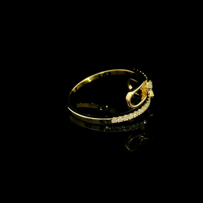 Diamond open bypass ring in 18K yellow gold with round diamonds, sweeping diamond-set curves and polished gold loops.