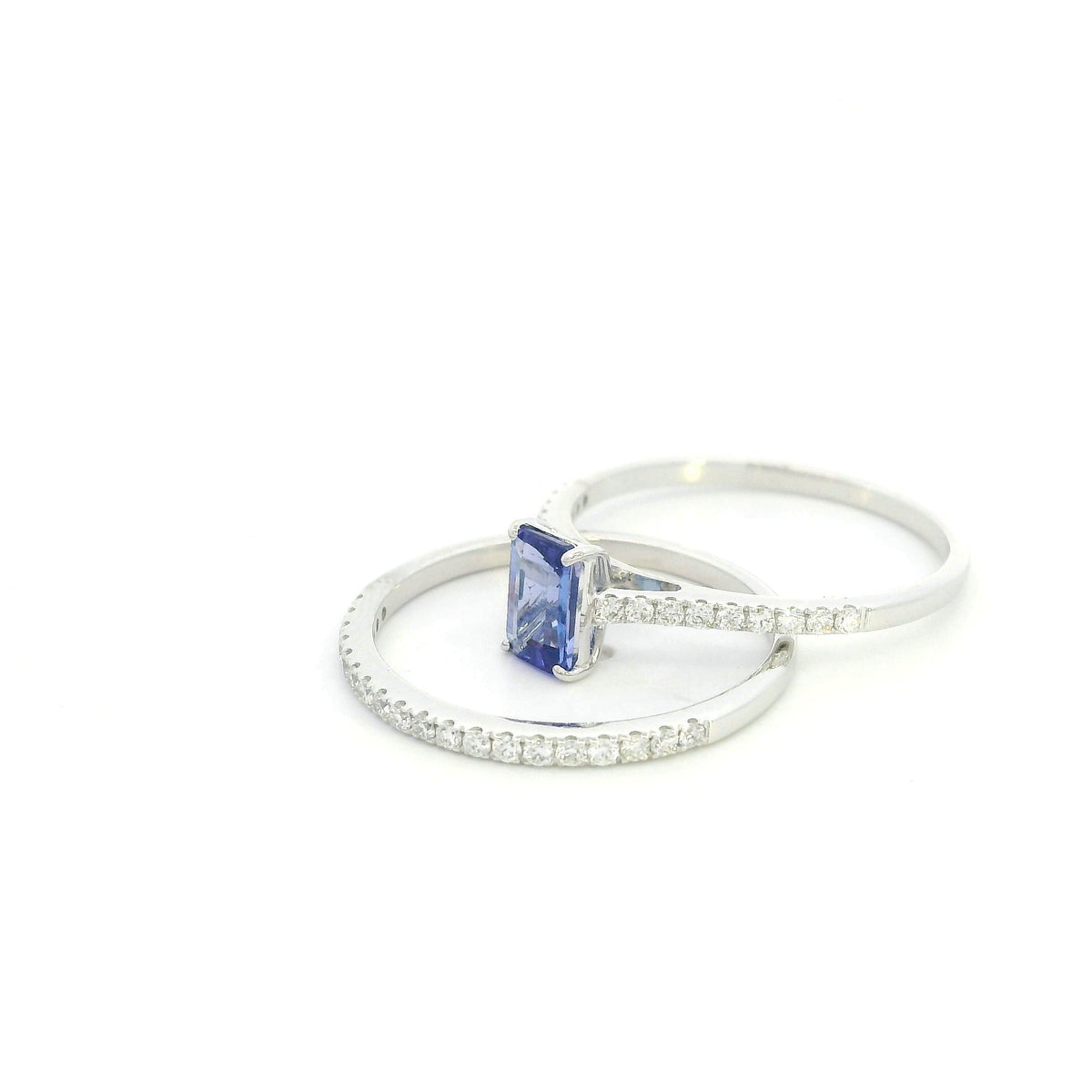 Tanzanite bridal set in 18K white gold with emerald cut tanzanite engagement ring and diamond wedding band