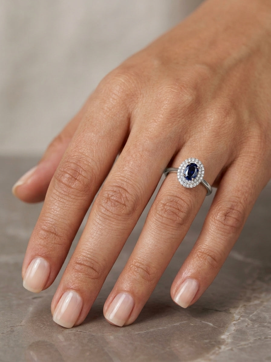 Oval blue sapphire double diamond halo ring in 18K white gold by Emirates Diamonds