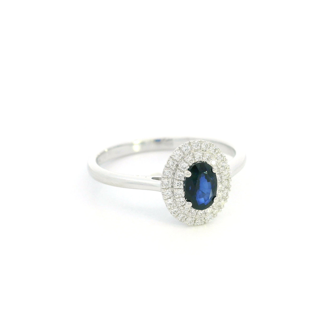 Oval blue sapphire double diamond halo ring in 18K white gold by Emirates Diamonds