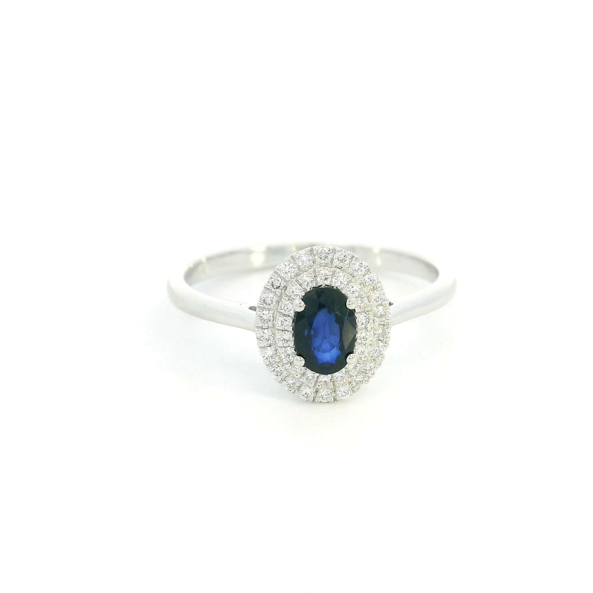 Oval blue sapphire double diamond halo ring in 18K white gold by Emirates Diamonds
